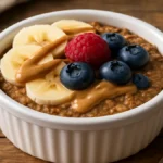 protein baked oats in ceramic ramekin with fresh toppings
