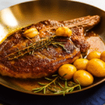 Bone in ribeye steak grilled to perfection on a wooden board